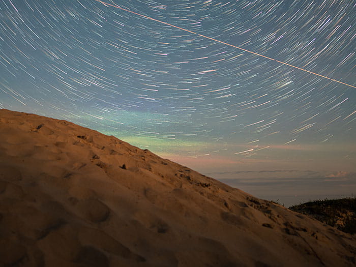 starry sky above sandy dune