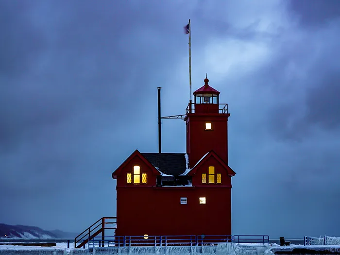 ice surrunding big red lighthouse
