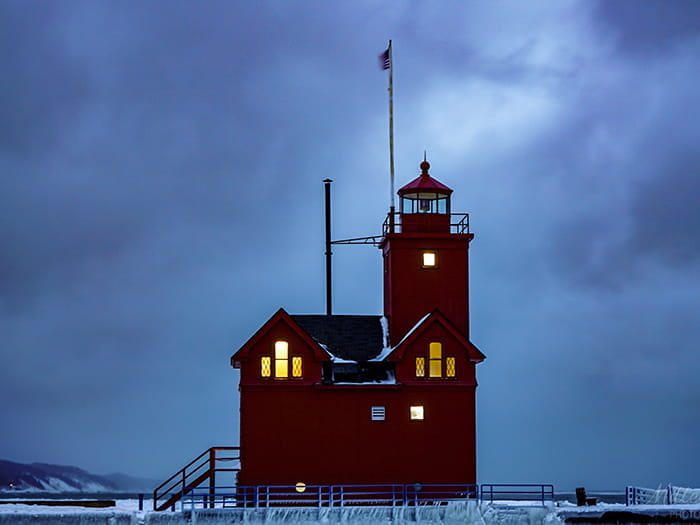 ice surrunding big red lighthouse