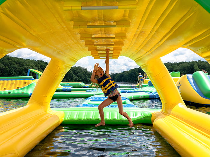 kid jumping at water park