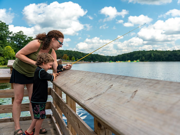 mom and son fishing on pier