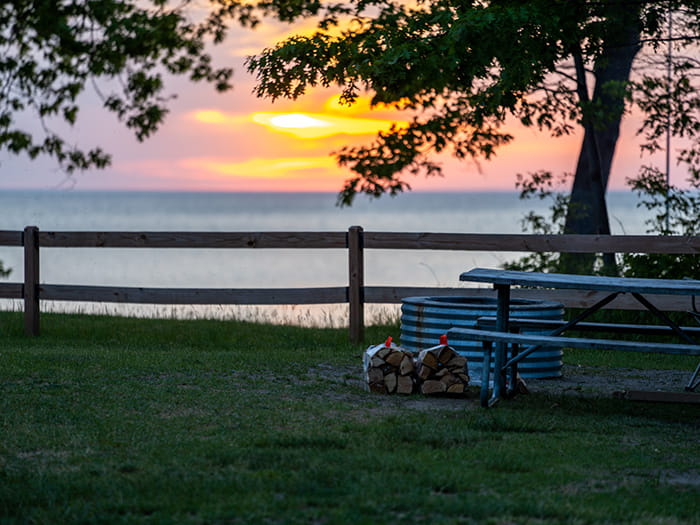 Sunset over the lake behind a campsite at Lakeport state park
