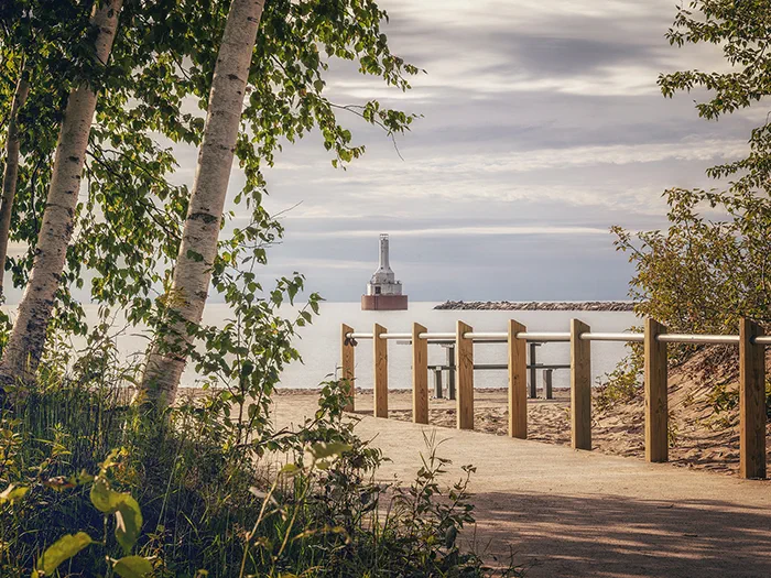 Keweenaw Waterway Lighthouse in distance with walkway leading to water