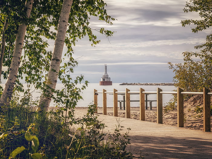 Keweenaw Waterway Lighthouse in distance with walkway leading to water