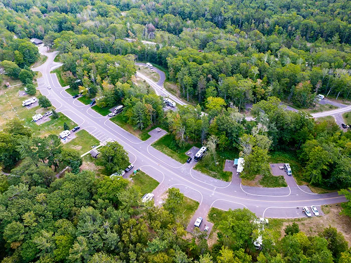birds eye view of campground sites surrounded by trees