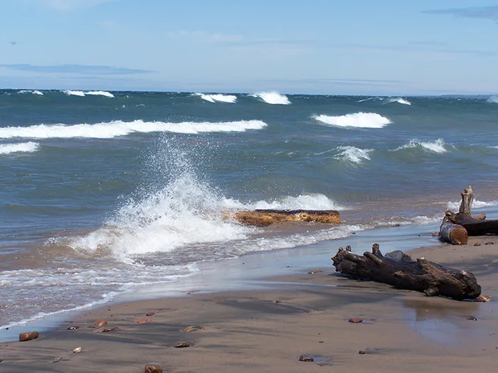 waves splashing against sandy shore