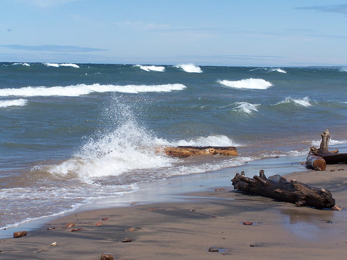 waves splashing against sandy shore