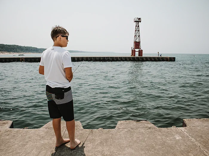 youth fishing off pier