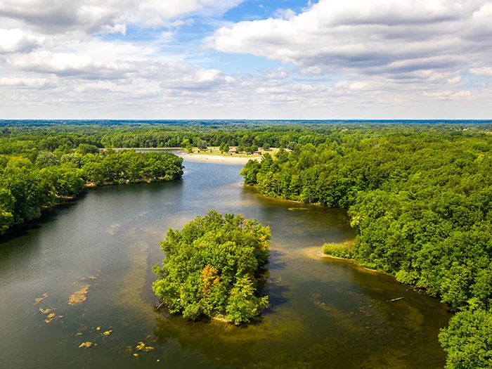 birds eye view of lake and tree covered land