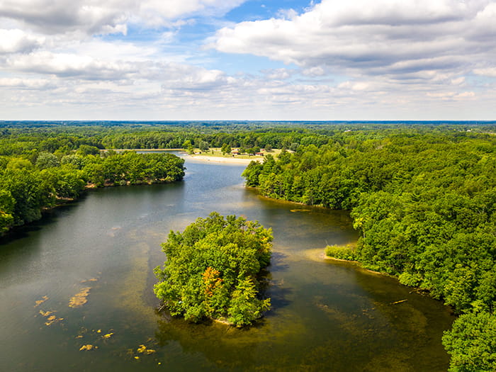 birds eye view of lake and tree covered land