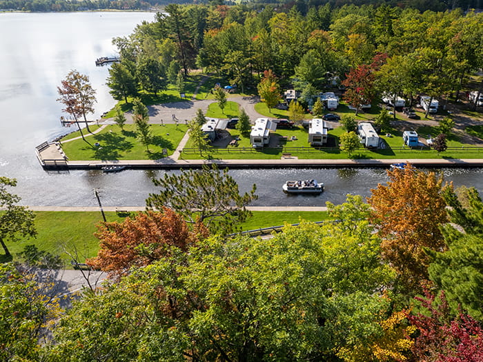 boat traveling canal with campsites bordering water