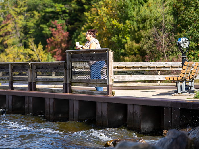 woman looking out at water from pier