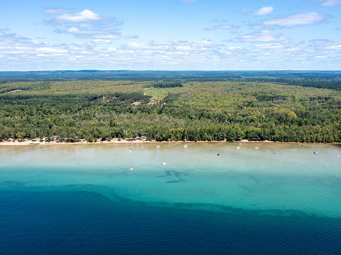 birds eye view of blue water and lakeshore