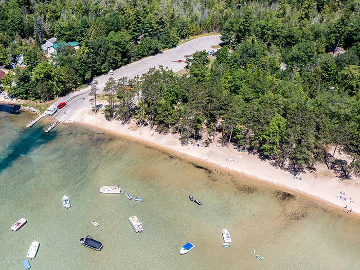 birds eye view of sandy shoreline and boating access site