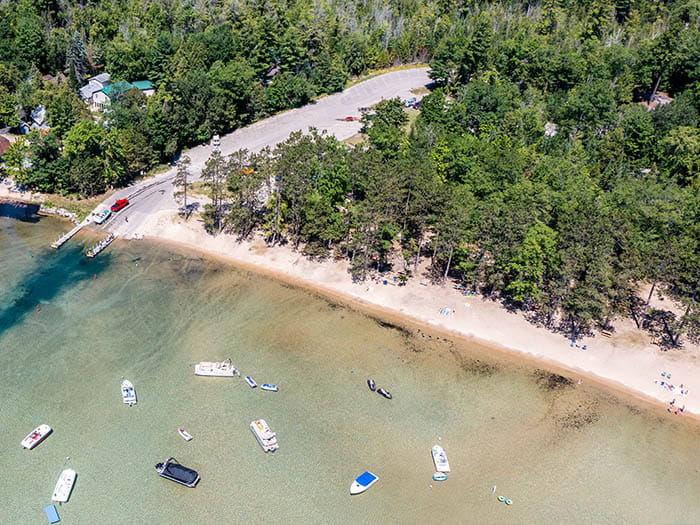 birds eye view of sandy shoreline and boating access site