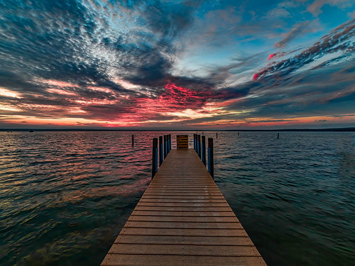 skid pier under pink and blue clouded sky