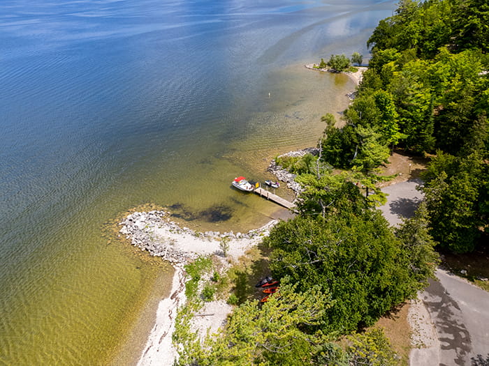 Birds eye view of water parking lot and boat ramp