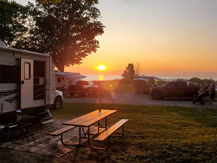 campers in camground with sun