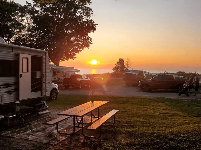 campers in camground with sun