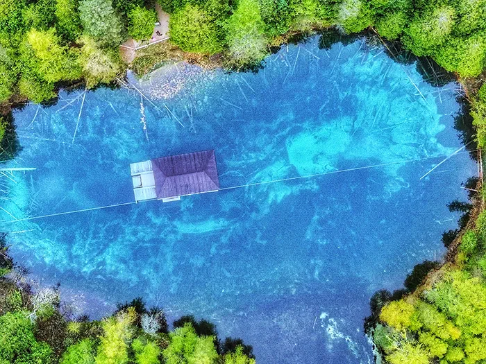 birds eye view of blue green colored lake and raft