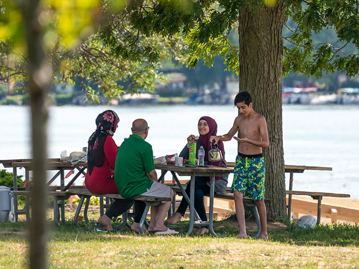 family sitting at picnic table