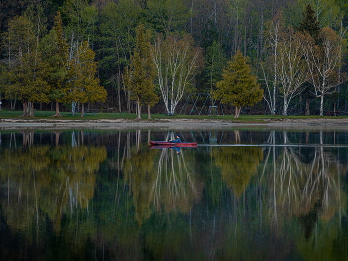 kayaker gliding across water at Rifle River