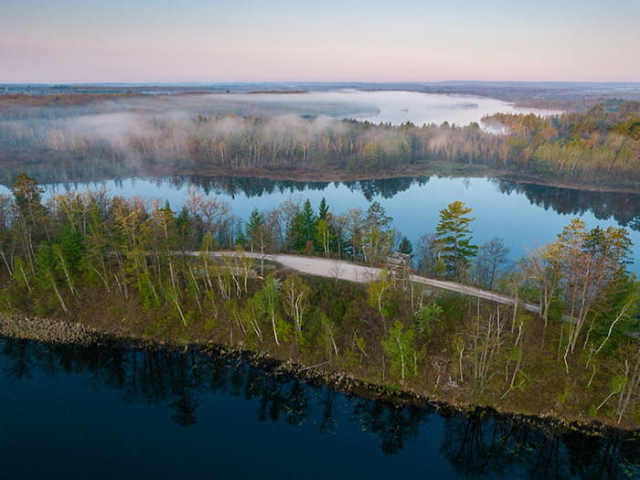 road surrounded by water on two sides at Rifle River