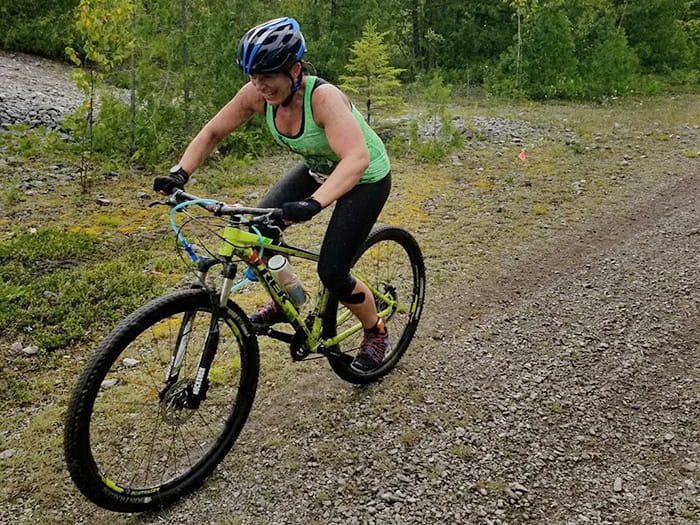 A woman mountain biking on a rocky trail at Rockport recreation area