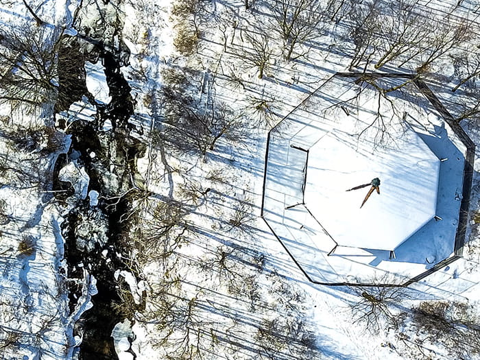 birds eye view of roofed enclosure and river