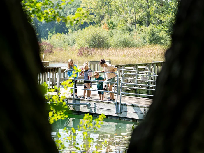 family looking at water from fishing pier