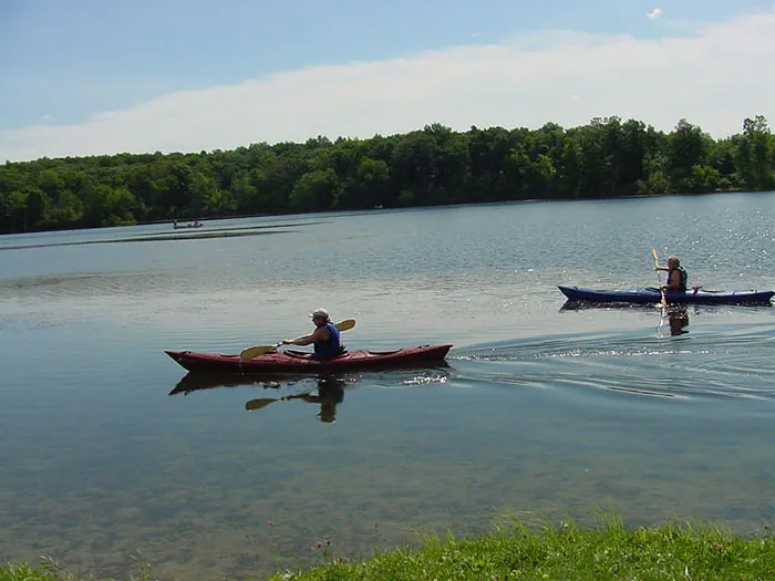 two kayakers paddling in lake