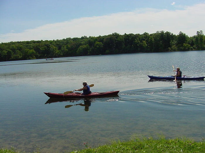 two kayakers paddling in lake