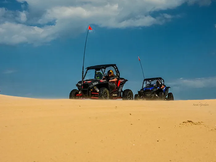 two buggies on top of dune
