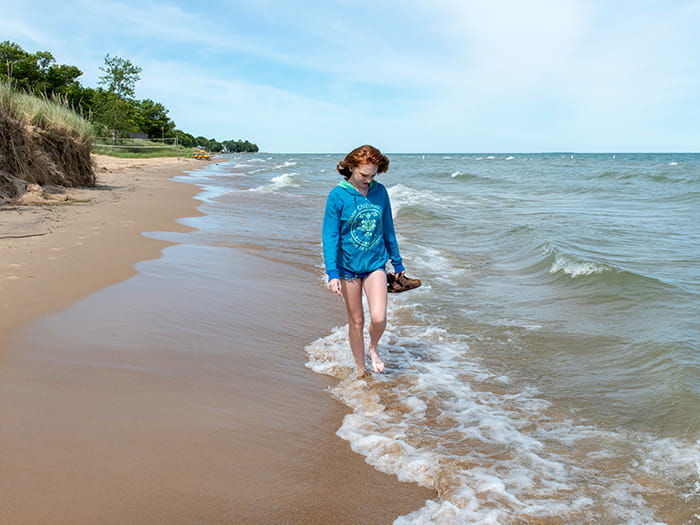 girl walking on sandy beach