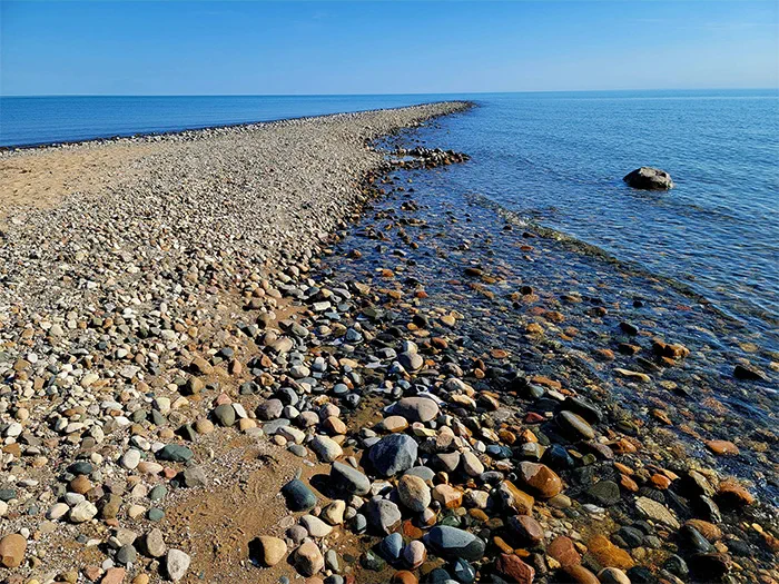 rocky reef surrounded by blue water