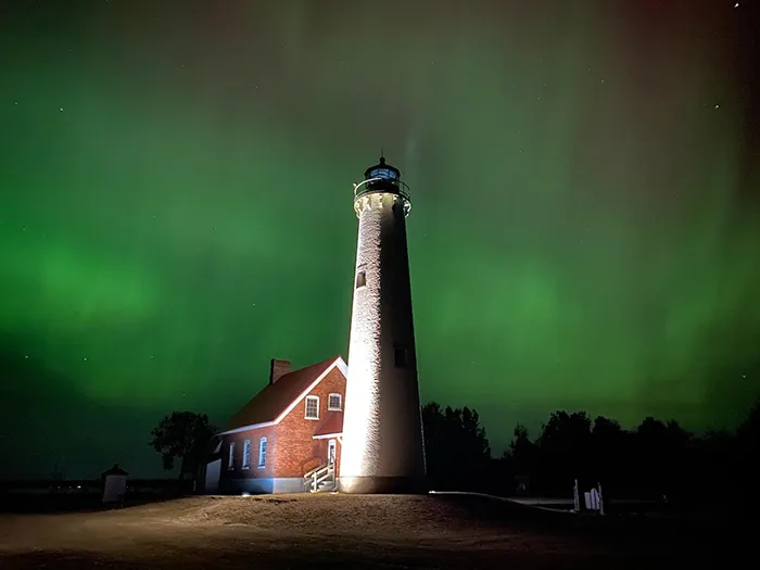 Tawas Lighthouse with greenish Northern Lights in the sky