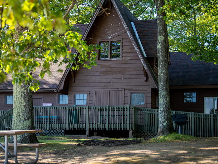 wood sided lodging facility with railed porch