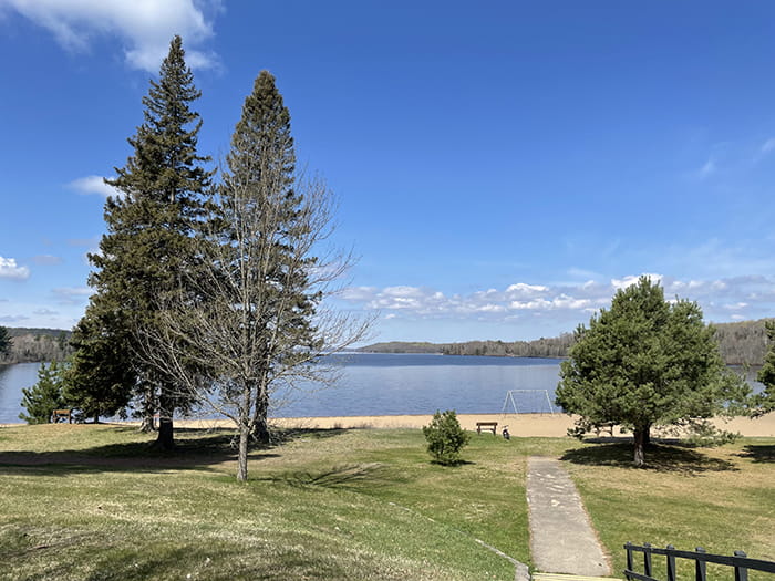 walkway to sandy beach on lake