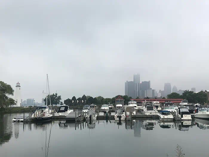 boats in harbor with misty sky