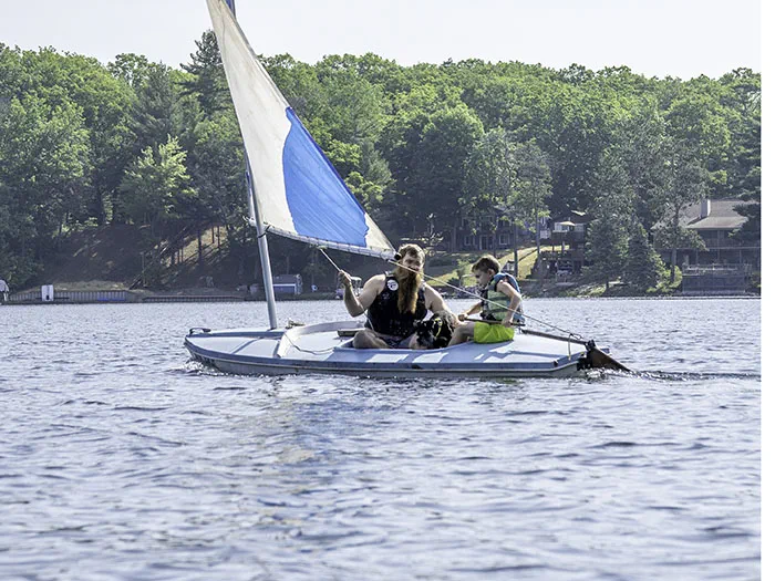 man and child sailing with life jackets