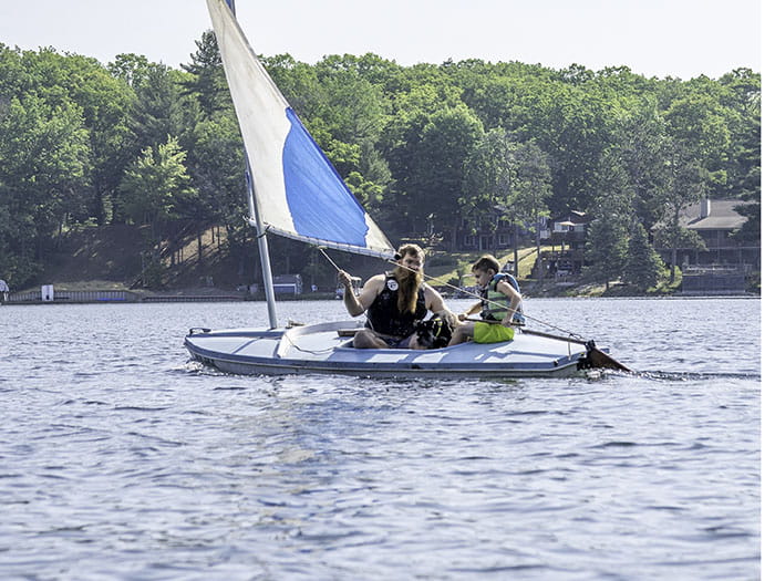man and child sailing with life jackets