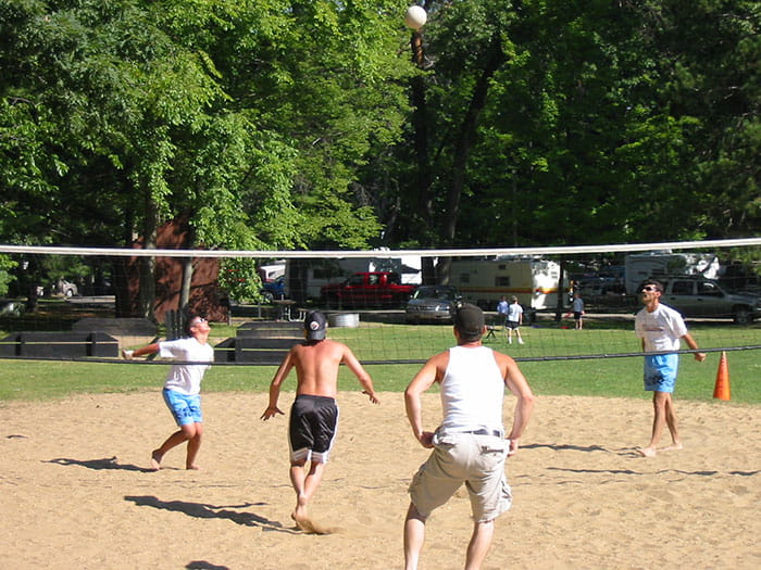 people playing sand volleyball
