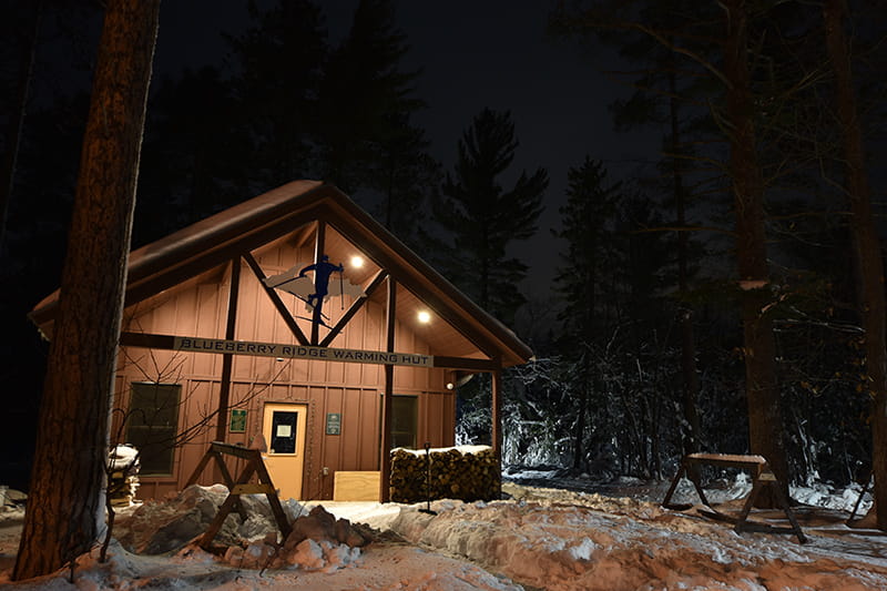 warming hut lit up at night