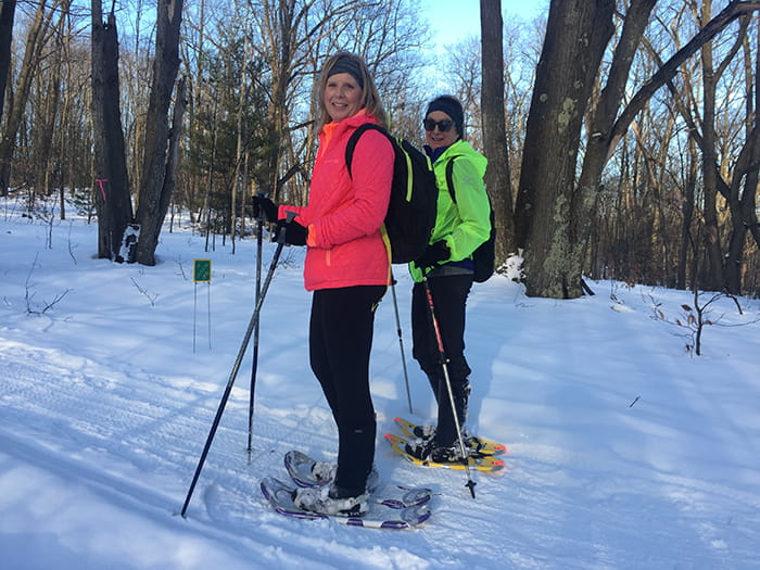Two snowshoers on the Cadillac Pathway