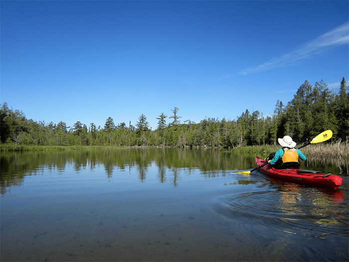 paddler paddling down river