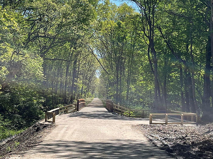 wide trail with small bridge