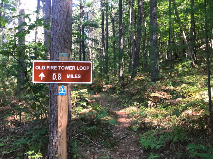 A sign marking the Old Fire Tower Loop on the Towerman