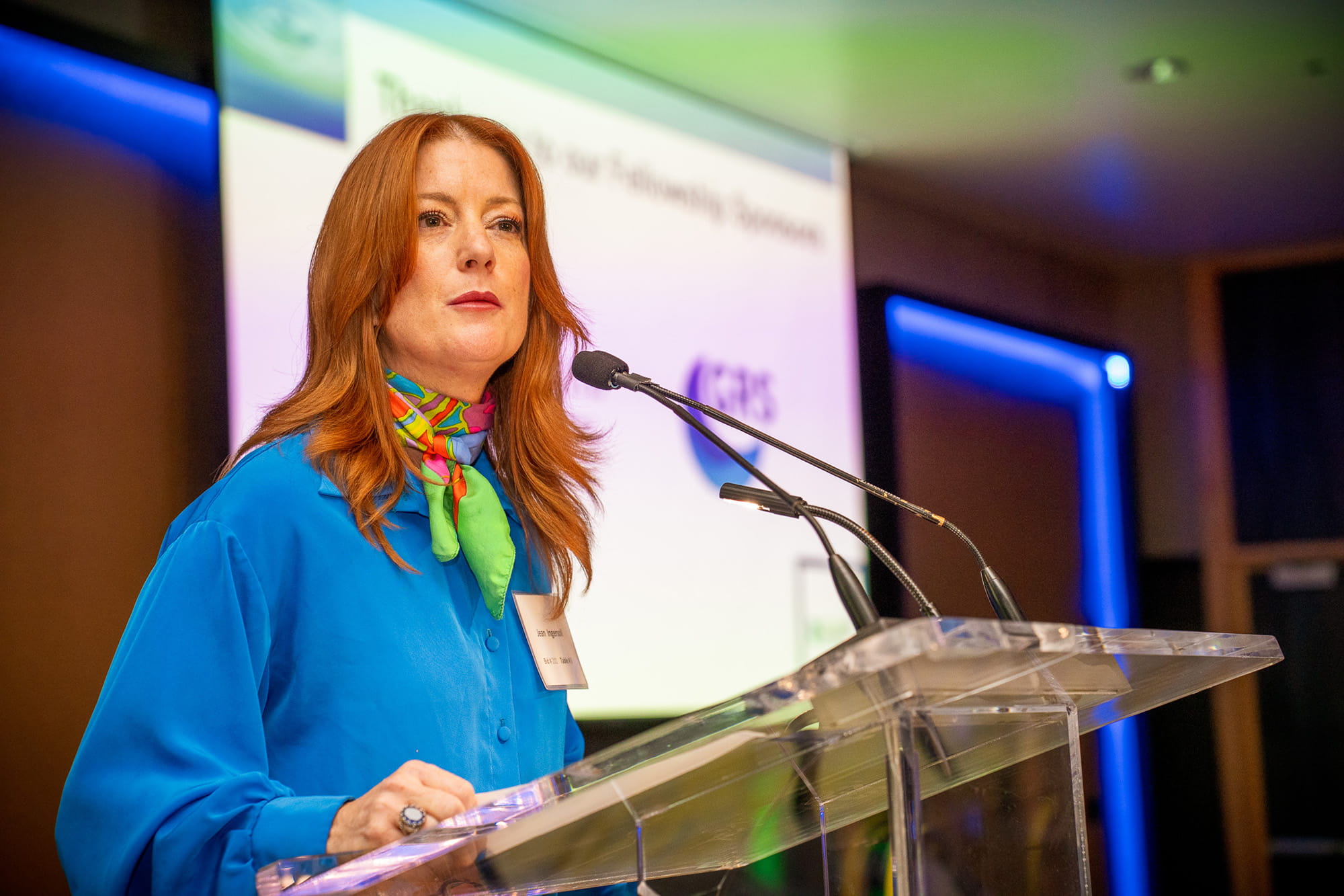 Jean at the podium, speaking to the audience