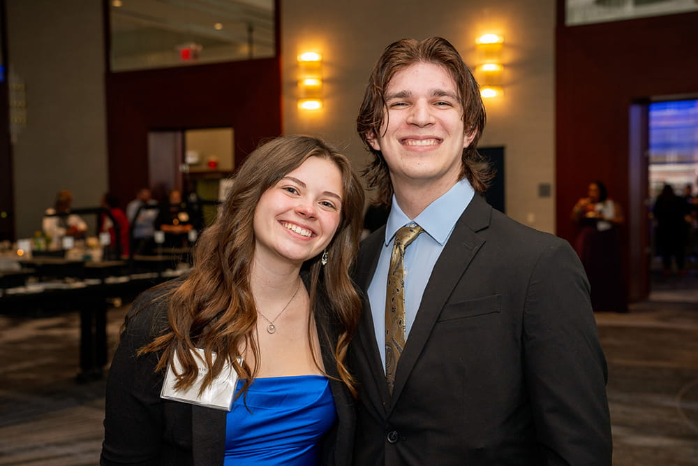 Two college students smile for the camera