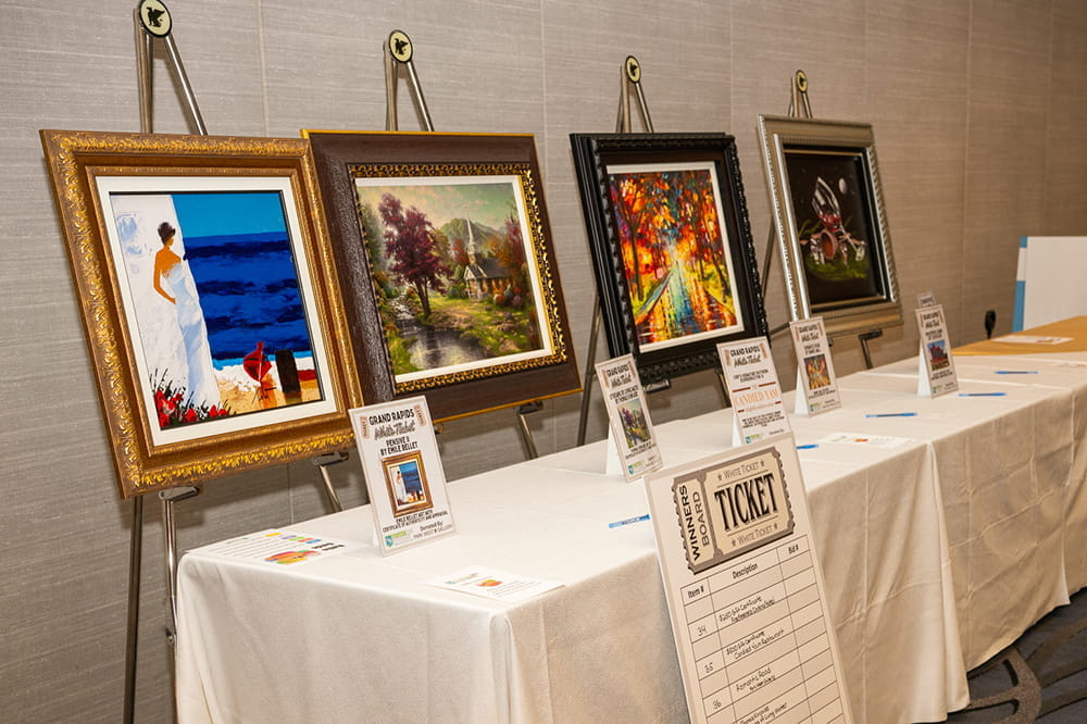 Four oil paintings on display for the raffle